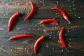 Red hot chili peppeprs on dark wooden background