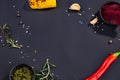 Red hot chili pepper corns and corn on black culinary background, top view Royalty Free Stock Photo