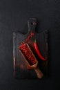 Red hot chili pepper. Place the red chili pepper on a wooden chopping board. Fresh chili pepper. Vertical photo.Flat lay