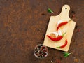 Red hot chili pepper pods and peas, cutting board, garlic clove Royalty Free Stock Photo