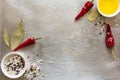 Red hot chili pepper pods peas, salt, oil and bay leaves on grey vintage metal culinary background Royalty Free Stock Photo