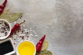 Red hot chili pepper pods peas, salt, oil, black cumin seeds and bay leaves on grey vintage metal culinary background Royalty Free Stock Photo