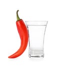 Red hot chili pepper and vodka in shot glass on white background Royalty Free Stock Photo