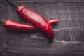 Red Hot Chili Peppers on Dark Rustic Wood Background Royalty Free Stock Photo