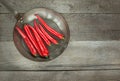 Red Hot Chili Peppers and pan on vintage wooden board. Top view with copy space. Royalty Free Stock Photo