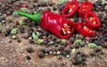 Red hot chili peppers and a mixture of different peppers on a wooden table. traditional spices. Royalty Free Stock Photo