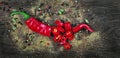 Red hot chili peppers and a mixture of different peppers on a wooden table. traditional spices. Royalty Free Stock Photo