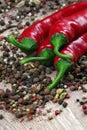 Red hot chili peppers and a mixture of different peppers on a wooden table. traditional spices. Royalty Free Stock Photo