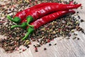 Red hot chili peppers and a mixture of different peppers on a wooden table. traditional spices. Royalty Free Stock Photo