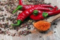 Red hot chili peppers and a mixture of different peppers on a wooden table. traditional spices. Royalty Free Stock Photo