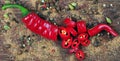 Red hot chili peppers and a mixture of different peppers on a wooden table. traditional spices. Royalty Free Stock Photo