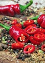 Red hot chili peppers and a mixture of different peppers on a wooden table. traditional spices. Royalty Free Stock Photo