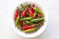 Red Hot Chili Peppers On Modern Background or White Table, on a Round Bowl. A Lot of Red Chilli Peppers. Green Hot Chili Peppers. Royalty Free Stock Photo