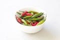 Red Hot Chili Peppers On Modern Background or White Table, on a Round Bowl. A Lot of Red Chilli Peppers. Green Hot Chili Peppers. Royalty Free Stock Photo