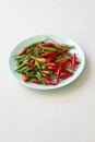 Red Hot Chili Peppers On Modern Background or White Table, on a Round Plate. A Lot of Red Chilli Peppers. Green Hot Chili Peppers Royalty Free Stock Photo