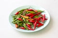 Red Hot Chili Peppers On Modern Background or White Table, on a Round Plate. A Lot of Red Chilli Peppers. Green Hot Chili Peppers Royalty Free Stock Photo