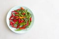 Red Hot Chili Peppers On Modern Background or White Table, on a Round Plate. A Lot of Red Chilli Peppers. Green Hot Chili Peppers Royalty Free Stock Photo