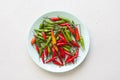 Red Hot Chili Peppers On Modern Background or White Table, on a Round Plate. A Lot of Red Chilli Peppers. Green Hot Chili Peppers Royalty Free Stock Photo