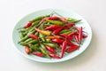 Red Hot Chili Peppers On Modern Background or White Table, on a Round Plate. A Lot of Red Chilli Peppers. Green Hot Chili Peppers Royalty Free Stock Photo