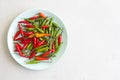 Red Hot Chili Peppers On Modern Background or White Table, on a Round Plate. A Lot of Red Chilli Peppers. Green Hot Chili Peppers Royalty Free Stock Photo