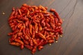 Red hot chili peppers outdoors. Close-up bunch of red peppers. From above pile of red pepper placed on dark board background. pepp