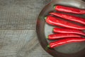 Red Hot Chili Peppers and pan on vintage wooden board. Top view with copy space. Royalty Free Stock Photo