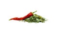 Red hot chili peppers and seasoning in form of a handful of green dried leaves, close-up isolated on a white background.