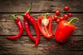 Red hot chili peppers, sweet pepper on wooden table Royalty Free Stock Photo