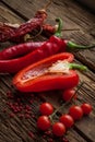 Red hot chili peppers, sweet pepper on wooden table Royalty Free Stock Photo