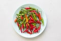 Red Hot Chili Peppers On Modern Background or White Table, on a Round Plate. A Lot of Red Chilli Peppers. Green Hot Chili Peppers Royalty Free Stock Photo