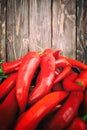 Red hot chili peppers on wood background