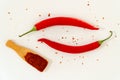 Red hot chili peppers, wooden spoon with paprika powder Royalty Free Stock Photo