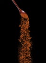 Red Hot Chilli fall, red grain chilli explode abstract cloud fly from wooden spoon. Beautiful complete seed chilly, food object