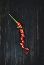 Red hot chilli pepper on black wood, top view Royalty Free Stock Photo