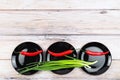 Red hot chilli pepper and scallions on plate Royalty Free Stock Photo