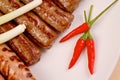 Red hot chilli peppers with grilled sausages and Royalty Free Stock Photo