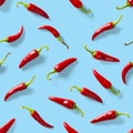 Seamless pattern made of red chili or chilli on blue background. Minimal food pattern. Red hot chilli seamless peppers pattern. Royalty Free Stock Photo