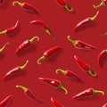 Seamless pattern made of red chili or chilli on red background. Minimal food pattern. Red hot chilli seamless peppers pattern. Royalty Free Stock Photo