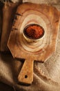 Red hot chillies pepper flakes in bowl on wooden board Royalty Free Stock Photo