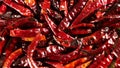 Red hot dried chiles de arbol peppers 4k video spinning clockwise slowly top down view