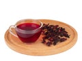 Red Hot Hibiscus tea in a glass cup on a wooden board with petals of dry hibiscus Royalty Free Stock Photo