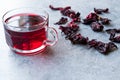 Red Hot Hibiscus Tea in a Glass Mug with Dry Hibiscus Tea Leaves Royalty Free Stock Photo