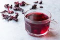 Red Hot Hibiscus Tea in a Glass Mug with Dry Hibiscus Tea Leaves Royalty Free Stock Photo