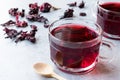 Red Hot Hibiscus Tea in a Glass Mug with Dry Hibiscus Tea Leaves. Royalty Free Stock Photo