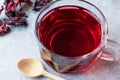 Red Hot Hibiscus Tea in a Glass Mug with Dry Hibiscus Tea Leaves Royalty Free Stock Photo
