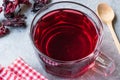 Red Hot Hibiscus Tea in a Glass Mug with Dry Hibiscus Tea Leaves. Royalty Free Stock Photo