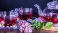 Red hot hibiscus tea in glass mug. Tea time: cup of tea, carcade, karkade, rooibos. Oriental, cozy, ceremony, tradition, japanese