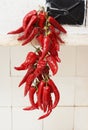 Red hot pepper getting drying at rural stove Royalty Free Stock Photo