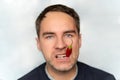 red hot pepper in the mouth close-up. Portrait of young man eating chili pepper Royalty Free Stock Photo