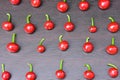 Hot chilli pimiento peppers pattern. Red cherry peppers isolated on black wooden background. Capsicum annuum Royalty Free Stock Photo